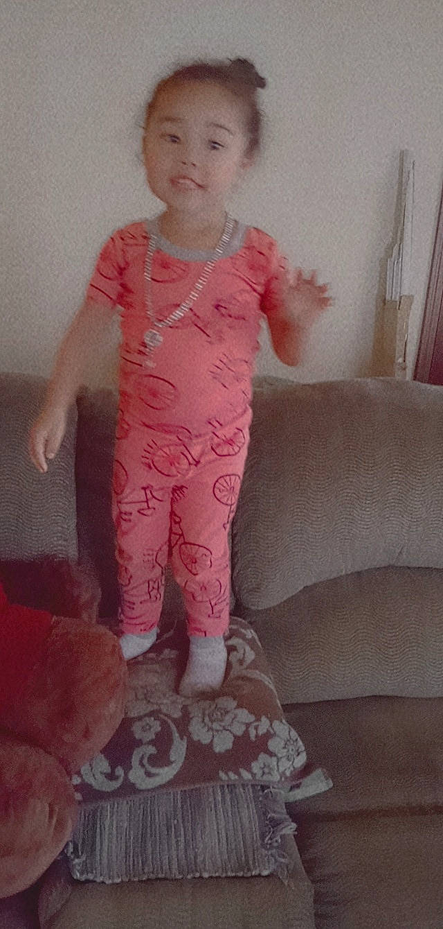 Chanelle is registered to the contest to win money with this photo: baby_toddler_clothing, child, comfort, flooring, human_leg, knee, leg, linens, magenta, neck, pattern, person, pink, room, skin, sleeve, sock, textile, thigh, toddler