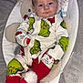 Ralphie joined the competition — help win amazing prizes! baby, infant, grinch_pajamas, red_booties, plush_baby_seat, holiday_clothing, cute, indoors, child, face, person, sleepwear, soft_toys, comfort, portrait, baby_accessory, cozy, young_child, expression, relaxing