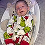 baby, infant, smiling, pajamas, grinch, red_booties, plush_toy, baby_seat, hanging_toys, heart_doodle, cozy, indoor, cute, child, clothing, comfort, portrait, holiday, soft_fabric, sleepwear