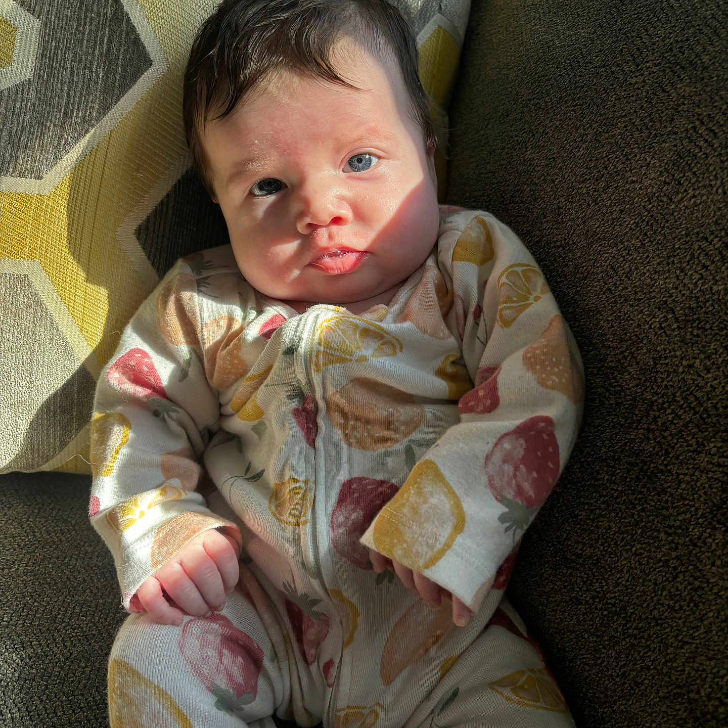 Evalyn is registered to the contest to win money with this photo: baby, bodypart, chair, clothing, couch, cushion, dress, face, finger, formalwear, furniture, hand, head, homedecor, newborn, pajamas, person, photography, portrait, sitting