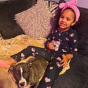 Kane joined the competition — help win amazing prizes! child, dog, puppy, couch, blanket, pillow, smile, pajamas, heart_pattern, headband, curly_hair, indoor, cozy, relaxing, friendship, pet, happy, living_room, comfort, cute