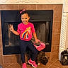 Eliana joined the competition — help win amazing prizes! black_dog, bright_colors, casual_clothing, child, decor, dog, fireplace, girl, happy, home, indoor, peace_sign, person, pet, pink_purse, pink_shoes, playful, smile, standing, tile_floor