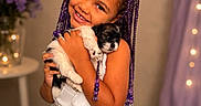 Eliana joined the competition — help win amazing prizes! beads, braided_hair, child, cute, decor, dog, flowers, girl, happy, hugging, indoor, lights, pet, portrait, puppy, purple_bow, smiling, table, toddler, white_dress