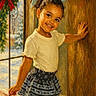 Eliana is registered to the contest to win money with this photo: blue_bow, child, curly_hair, cute, door, festive, girl, happy, holiday, indoor, patterned_skirt, portrait, red_bow, smiling, snow, warm_light, white_shirt, window, wood, wreath