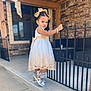 Eliana is registered to the contest to win money with this photo: child, city, clothing, dress, face, female, girl, head, jeans, outdoors, pants, person, photography, portrait, road, sitting, sleeve, street, urban, wood
