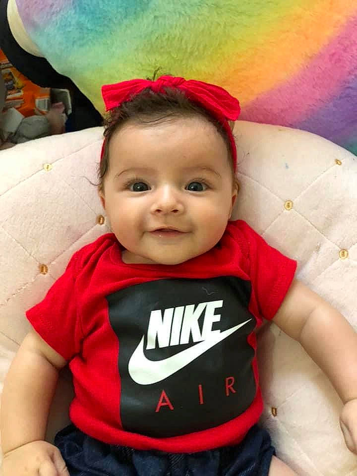 Kehlani is registered to the contest to win money with this photo: arm, baby, baby_toddler_clothing, cheek, eye, facial_expression, fun, hairstyle, happy, headgear, human_body, joy, mouth, person, pink, red, skin, smile, t_shirt, textile