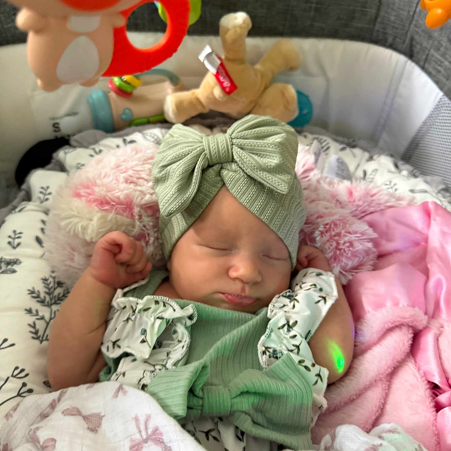 Athena Raven joined the competition — help win amazing prizes! baby, baby_gear, blanket, bow, child, clothing, cozy, crib, cute, green_outfit, headband, indoors, infant, newborn, peaceful, pink_blanket, plush_toy, resting, sleeping, soft_toy