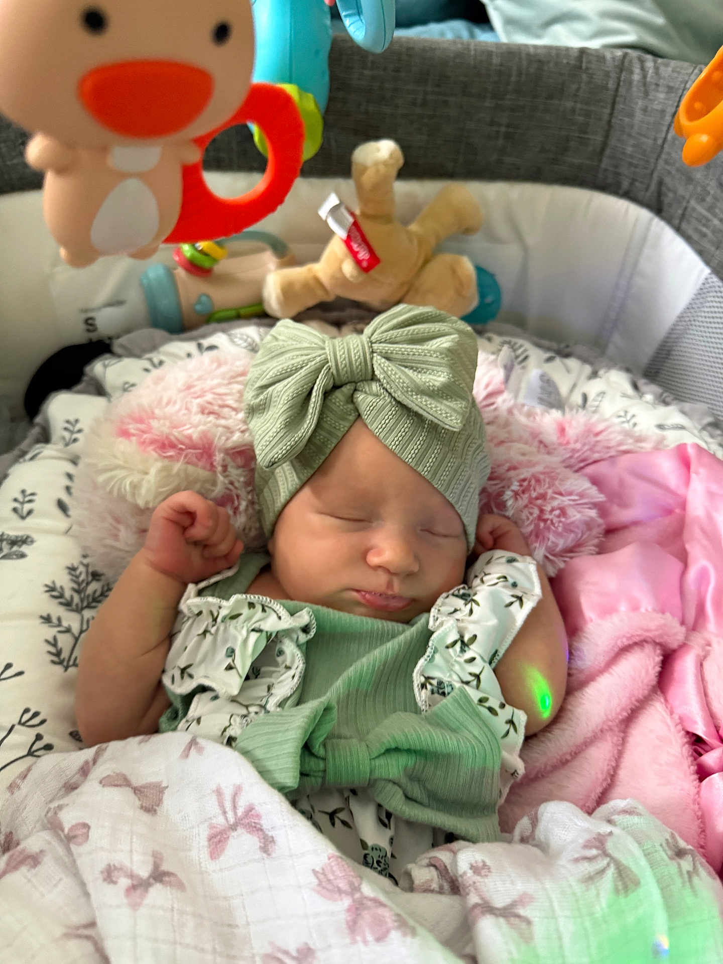 Athena Raven joined the competition — help win amazing prizes! baby, sleeping, headband, bow, blanket, plush_toy, infant, clothing, soft_toy, crib, baby_gear, peaceful, cute, newborn, pink_blanket, green_outfit, resting, indoors, child, cozy