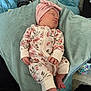 Athena Raven is registered to the contest to win money with this photo: baby, sleeping, onesie, floral_pattern, headband, pink, cushion, blue, footwear, crocs, colorful, indoor, person, infant, cozy, soft, resting, cute, newborn, home