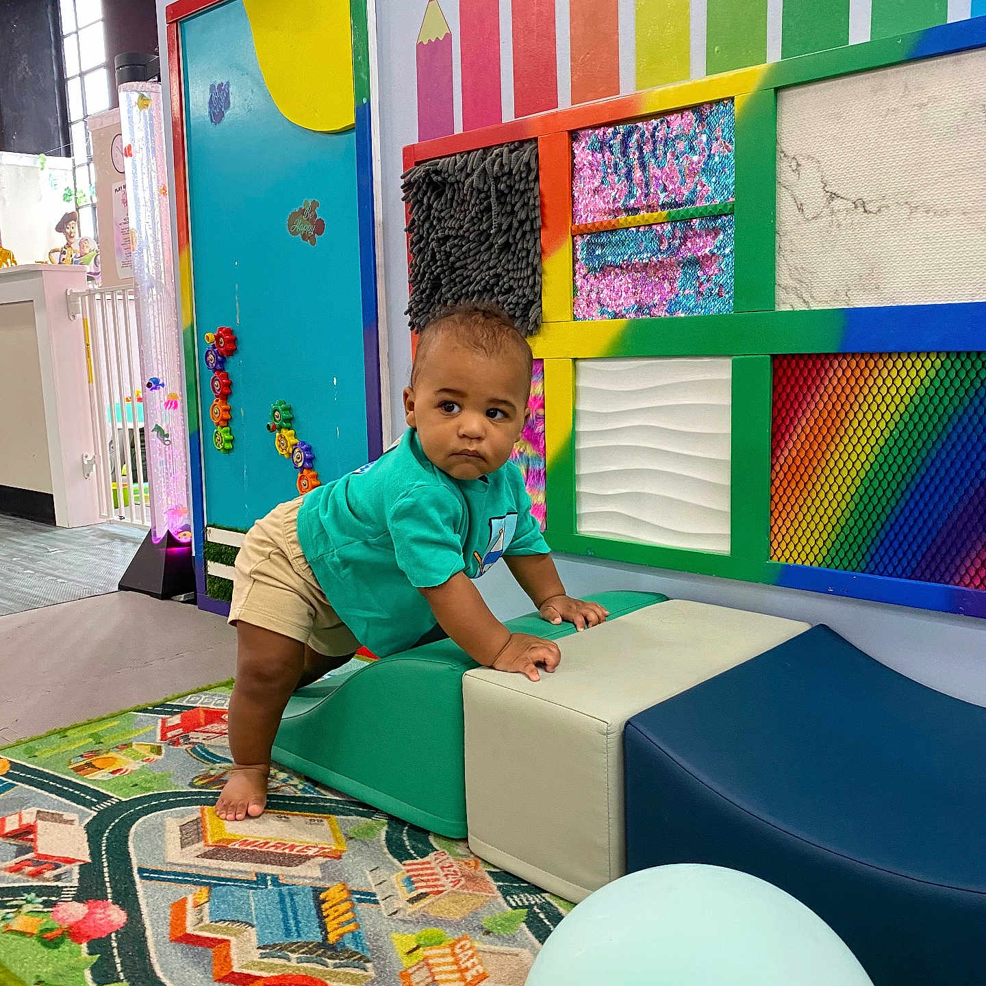 Tatum is registered to the contest to win money with this photo: baby, balloon, child, classroom, colorful, crawling, face, indoor, padded_equipment, pencils, playground, playroom, portrait, road_map, rug, smiling, soft_play, standing, toddler, wall_decor