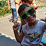 boy, casual_clothing, chair, child, concrete, fence, friends, fun, garden, happy, outdoor, parked_car, people, plants, playful, smile, summer, sunglasses, sunlight, table