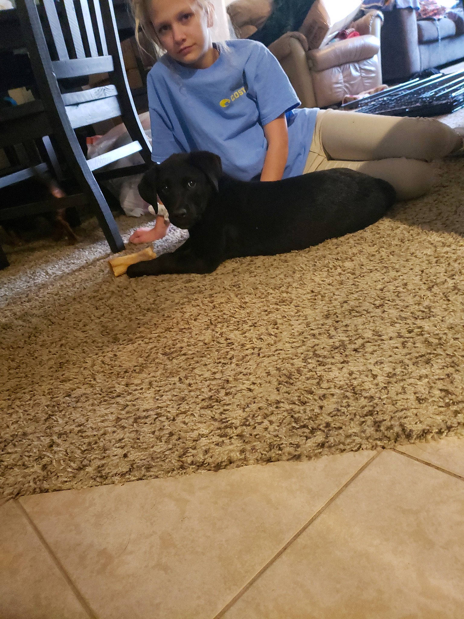 Coco is registered to the contest to win money with this photo: carpet, child, floor, flooring, foot, leg, sitting