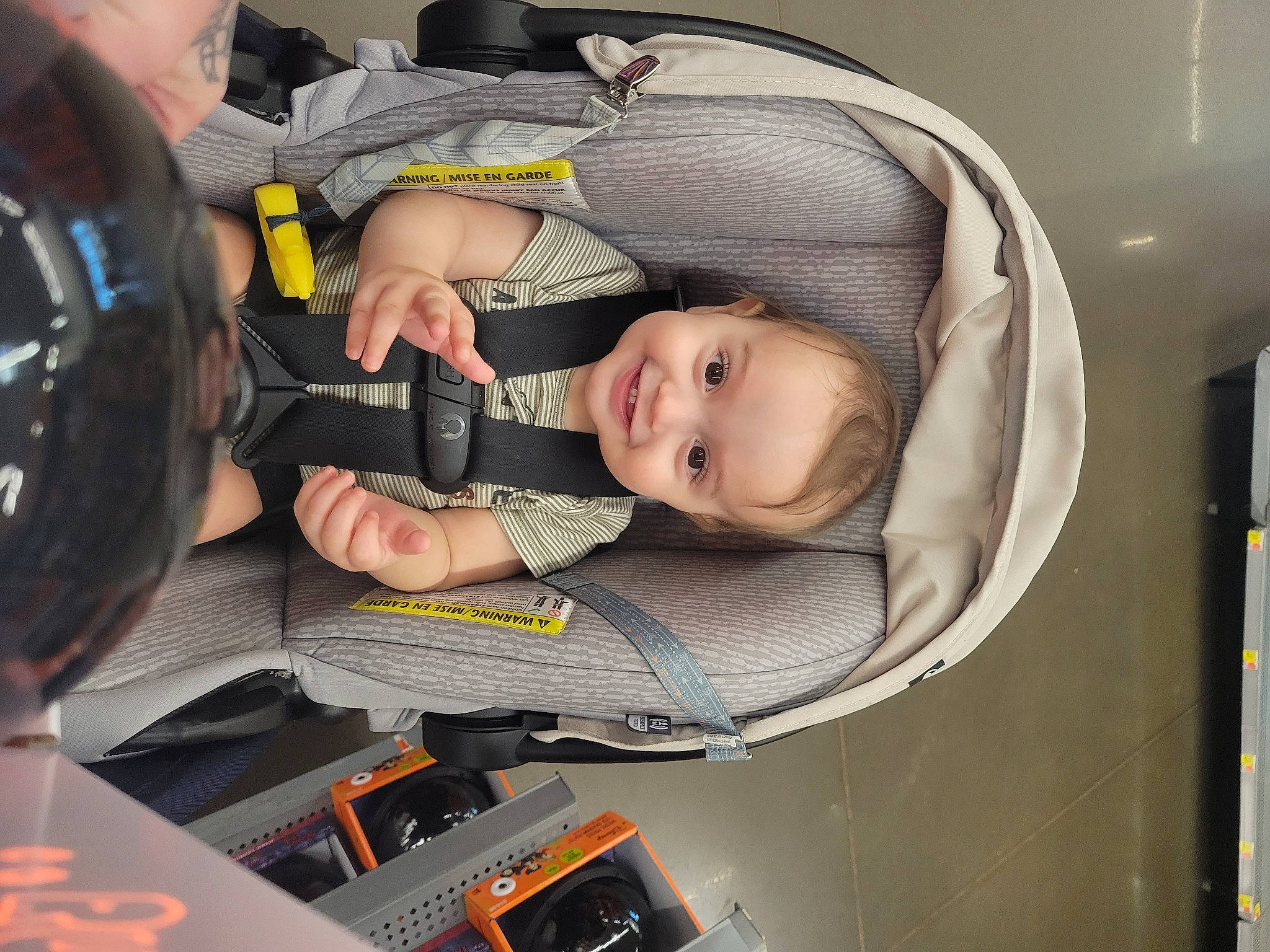 Grayson is registered to the contest to win money with this photo: auto_part, baby, baby_carriage, baby_products, baby_safety, baby_toddler_clothing, car_seat, carmine, child, comfort, fun, joy, mouth, person, room, sitting, smile, toddler