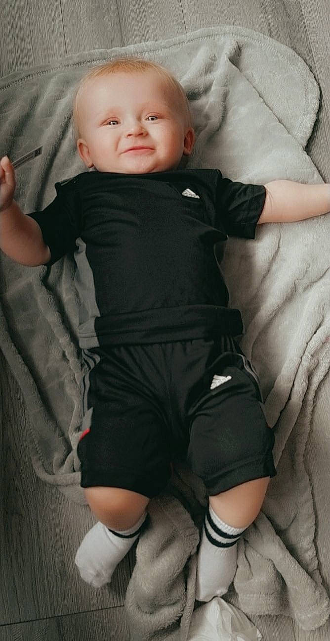 Corey And Caiden is registered to the contest to win money with this photo: baby_toddler_clothing, cheek, chin, comfort, eye, gesture, head, human, iris, joint, leg, muscle, neck, nose, person, skin, sleeve, smile, standing, textile