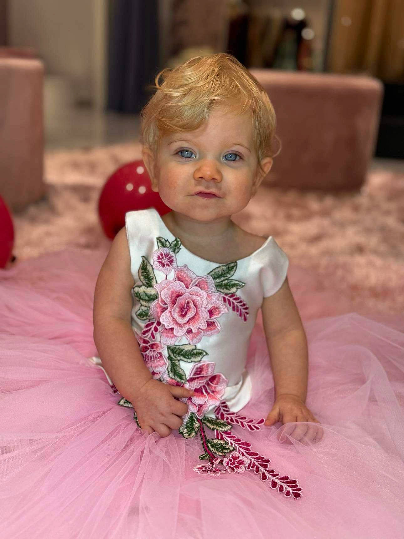 Alayna participe au concours pour gagner de l'argent avec cette photo : baby, baby_toddler_clothing, cheek, child, dress, embellishment, event, eye, facial_expression, flash_photography, flooring, fun, hairstyle, happy, iris, person, petal, pink, skin, smile