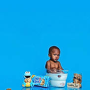 Chad is registered to the contest to win money with this photo: toddler, child, milk, cookie, cookies, cookie_jar, chips_ahoy, cookie_monster, blue_background, glass_bowl, milk_bath, snack, food, playful, cute, studio_shot, reflection, sitting, portrait, funny