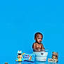 toddler, child, milk, cookie, cookies, cookie_jar, chips_ahoy, cookie_monster, blue_background, glass_bowl, milk_bath, snack, food, playful, cute, studio_shot, reflection, sitting, portrait, funny