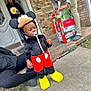 Chad joined the competition — help win amazing prizes! adult, black_top, box, brick_wall, casual_clothing, child, concrete, costume, door, grass, mickey_mouse, outdoor, pacifier, person, porch, red_shorts, sidewalk, toddler, toy_box, yellow_shoes