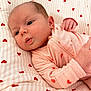 baby, infant, newborn, onesie, pink, hearts_pattern, bedding, blanket, crib, cute, adorable, face, eyes, hand, portrait, closeup, lying_down, soft, sleepwear, nursery