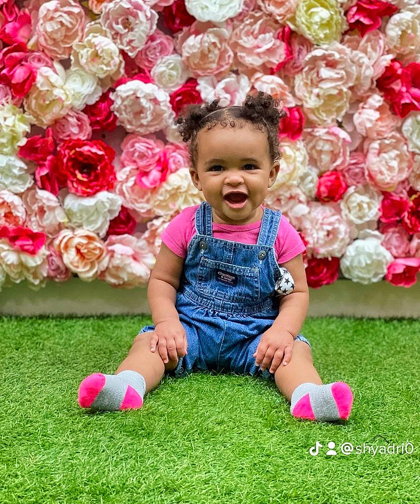 Akeelah joined the competition — help win amazing prizes! baby_toddler_clothing, blossom, botany, flower, flower_arranging, fun, grass, happy, hybrid_tea_rose, magenta, people_in_nature, person, petal, pink, plant, red, rose, shoe, smile, sneakers