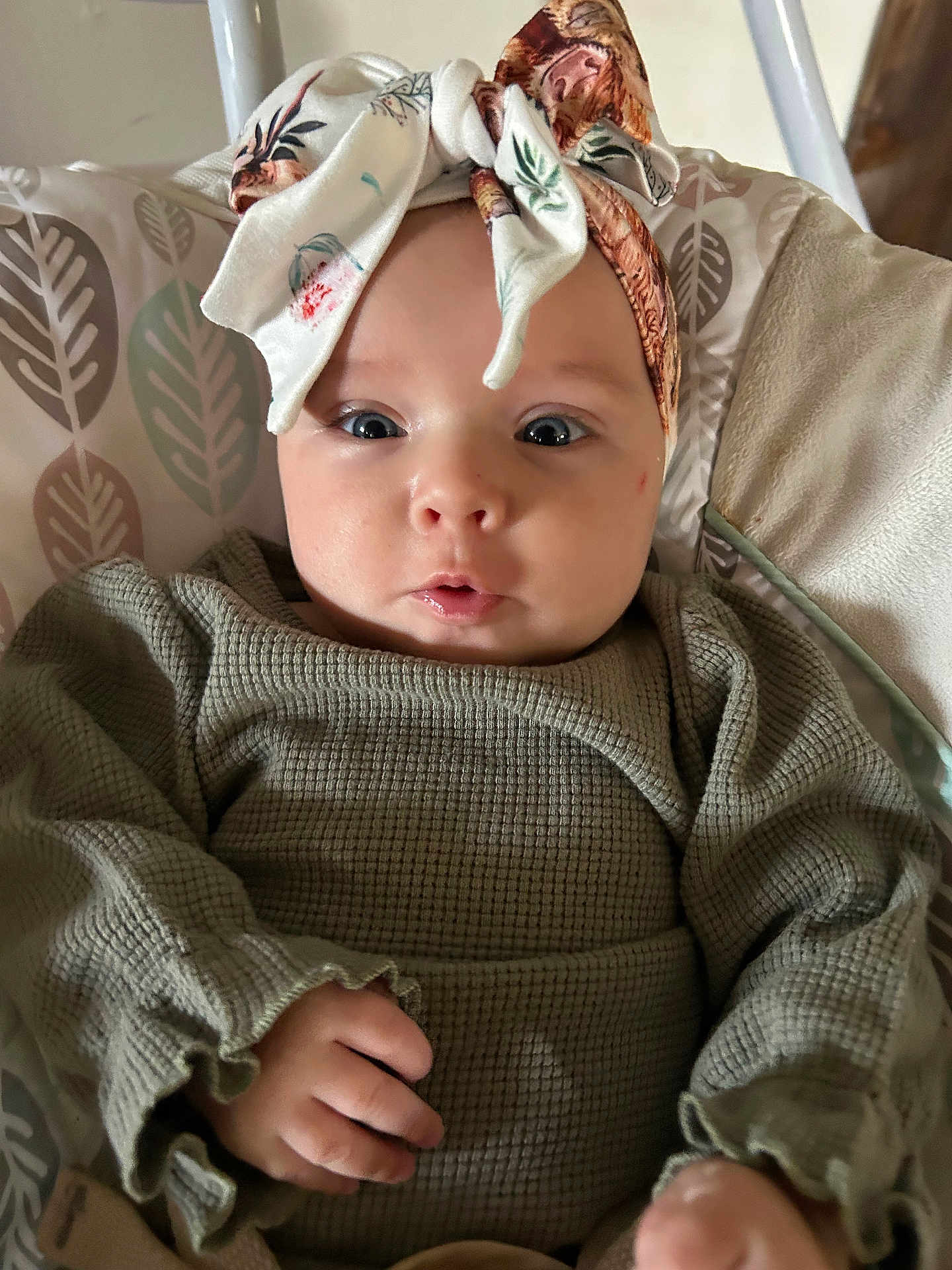 Elena is registered to the contest to win money with this photo: baby, headband, infant, clothing, cushion, pattern, face, hand, portrait, cute, child, expression, indoor, person, fabric, green, seat, closeup, young, soft