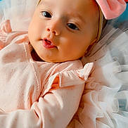 Zaynah joined the competition — help win amazing prizes! adorable, baby, blanket, bow, child, close_up, colorful_background, cute, face, happy, headband, indoors, infant, lying_down, newborn, peaceful, pink_clothing, portrait, ruffles, soft_fabric