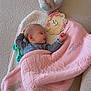 baby, sleeping, blanket, pink, plush_toy, bear, wooden_sign, 3_months, floor, soft_texture, striped_clothing, child, infant, peaceful, cozy, knitted, cute, lying_down, indoor, resting