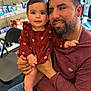 Lesly is registered to the contest to win money with this photo: baby, man, child, holding, pharmacy, sitting, shelf, product, clothing, indoor, smiling, beard, jeans, chair, window, foot, hand, face, casual, parent