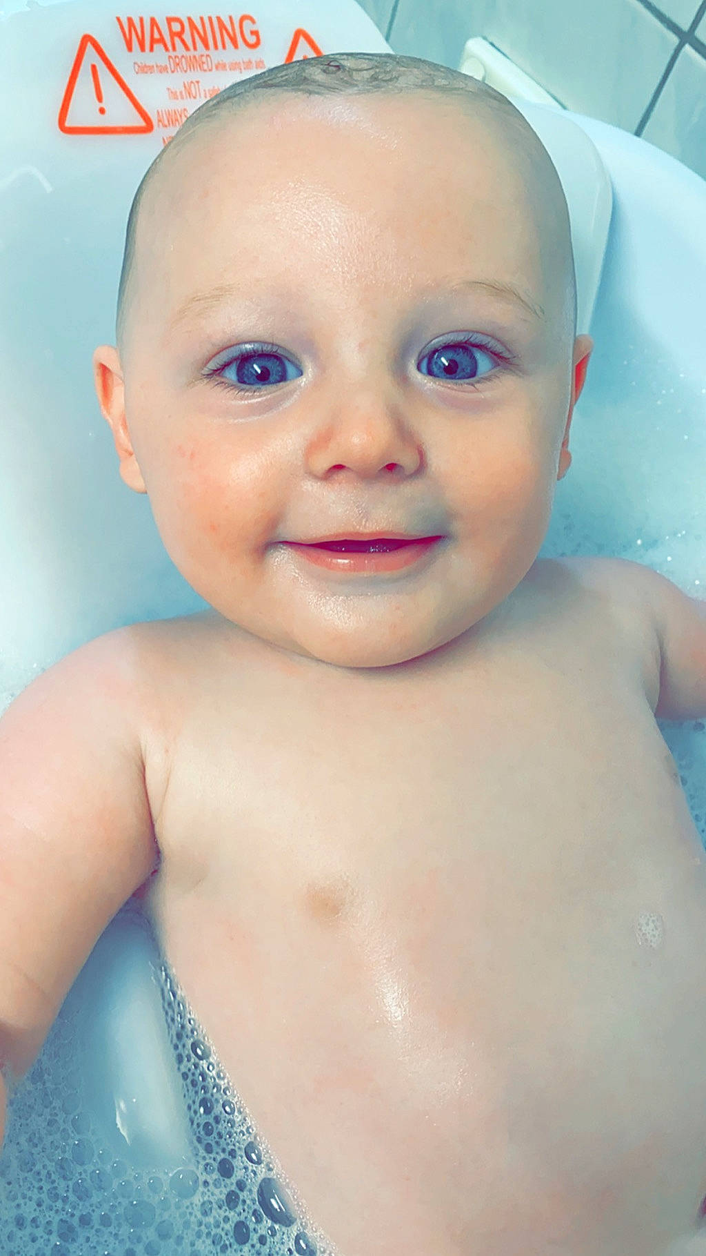Hurley is registered to the contest to win money with this photo: baby, baby_bathing, baby_making_funny_faces, bathing, bathtub, cheek, child, chin, eye, eyebrow, face, facial_expression, forehead, head, lip, nose, person, skin, smile, toddler