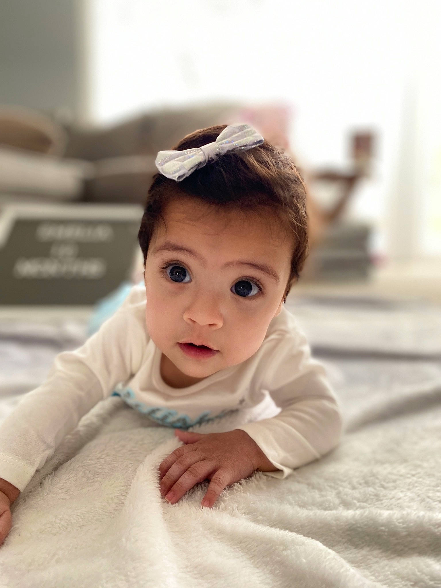 Emelia is registered to the contest to win money with this photo: baby, beauty, cheek, child, crawling, eye, face, floor, flooring, forehead, head, person, photograph, photography, portrait_photography, sitting, skin, smile, snapshot, surprise