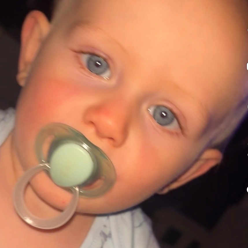 Lenni joined the competition — help win amazing prizes! baby, blue_eyes, child, close_up, cute, expression, face, head, indoor, infant, newborn, onesie, pacifier, person, portrait, skin, sleepwear, soft_lighting, wearing, young