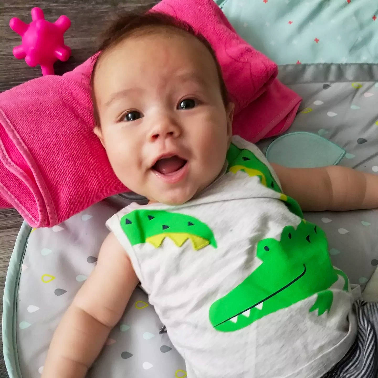 Jayce is registered to the contest to win money with this photo: baby, baby_products, baby_safety, baby_toddler_clothing, cheek, child, comfort, facial_expression, fun, happy, linens, outerwear, person, pink, product, skin, sleeve, smile, t_shirt, textile