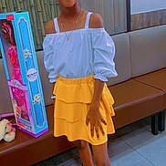 Paris joined the competition — help win amazing prizes! child, girl, indoor, yellow_skirt, white_top, bunny_ears, glowing_accessory, doll_box, stuffed_animal, bench, floor_tiles, smiling, standing, fashion, accessories, heart_emojis, portrait, person, casual, happy