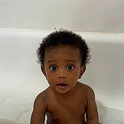 Kahyir is registered to the contest to win money with this photo: baby, child, bathtub, curly_hair, water, skin, face, eyes, innocent, cute, portrait, indoor, person, young_child, bath_time, expression, sitting, naked_torso, curious, looking_at_camera