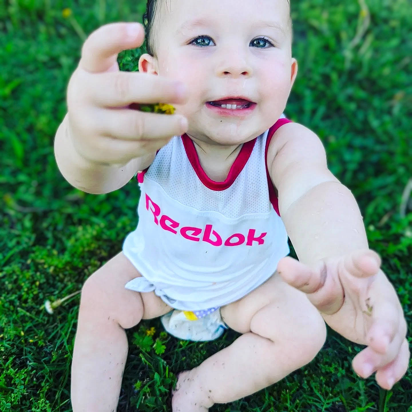 Allicynn is registered to the contest to win money with this photo: baby, baby_toddler_clothing, eye, face, finger, gesture, grass, green, hand, happy, head, people_in_nature, person, photograph, plant, skin, sleeve, smile, thumb, toddler