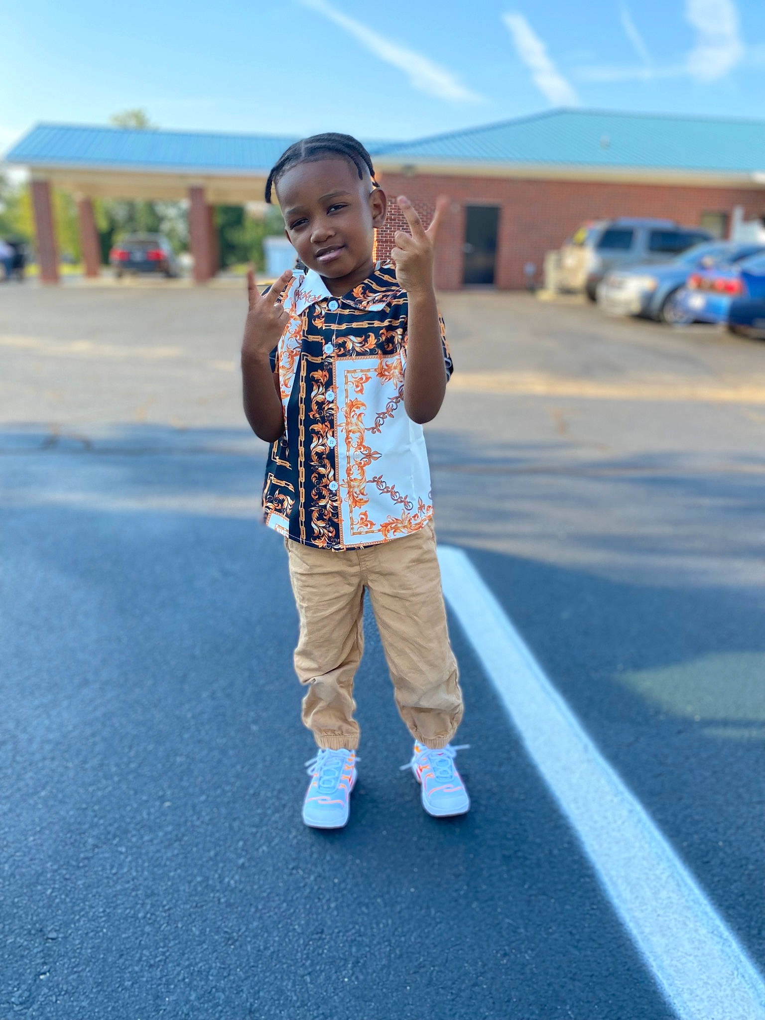 Langston is registered to the contest to win money with this photo: asphalt, azure, blue, cloud, electric_blue, eyewear, fun, hair, happy, leisure, pattern, person, recreation, road, shorts, sky, street, t_shirt, toddler, travel