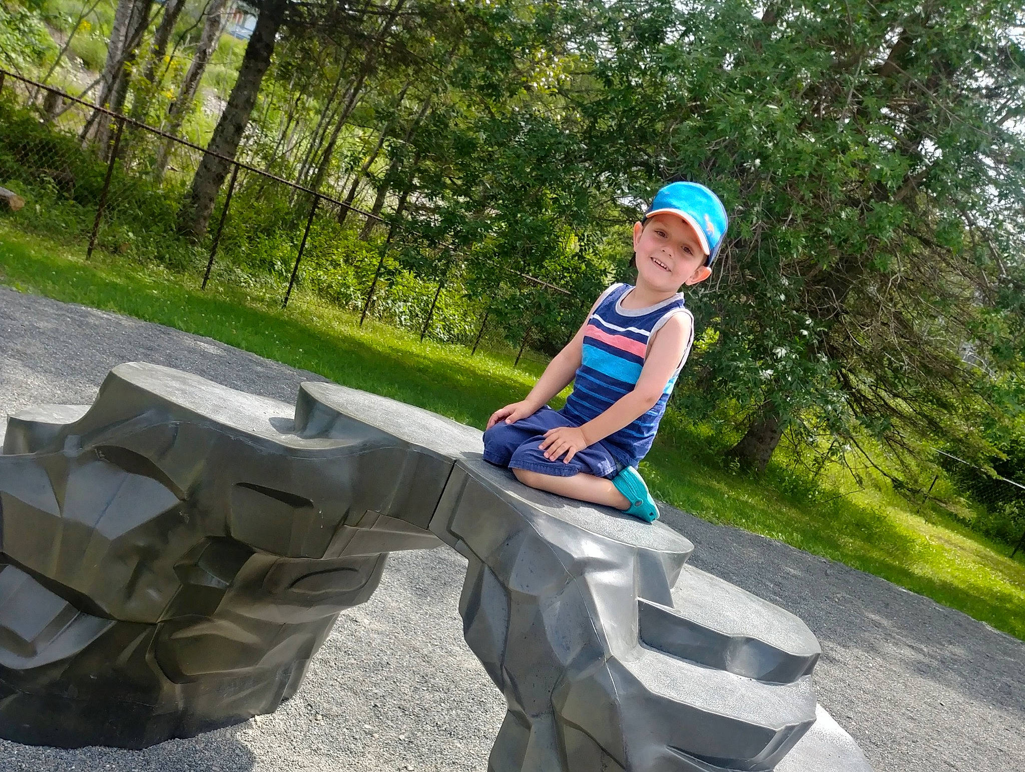 Jacob participe au concours pour gagner de l'argent avec cette photo : child, headwear, joy, park, person, play, recreation, sculpture, sitting, toddler, tree