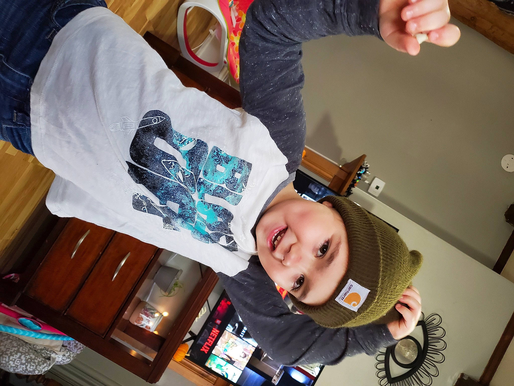 Sam is registered to the contest to win money with this photo: baby, baby_toddler_clothing, cheek, child, cool, elbow, eyewear, fun, happy, headwear, mouth, person, room, sitting, sleeve, smile, suit, t_shirt, toddler, wrist