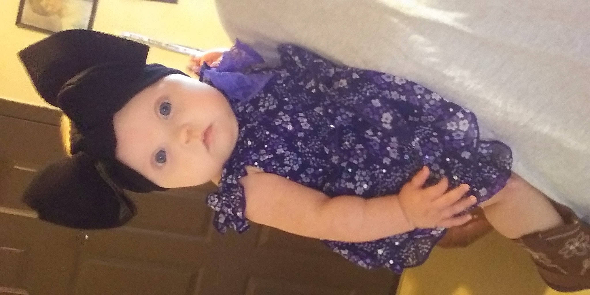 Tallie is registered to the contest to win money with this photo: baby, baby_toddler_clothing, cheek, child, electric_blue, fashion_accessory, fun, gesture, hat, headgear, headwear, human_body, human_leg, nail, pattern, person, purple, sleeve, thumb, toddler