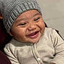 Elijah participe au concours pour gagner de l'argent avec cette photo : baby, smiling, happy, infant, hat, knit_hat, onesie, striped_clothing, closeup, portrait, cute, child, face, cheerful, hands, warm_clothing, indoors, skin, joy, expression