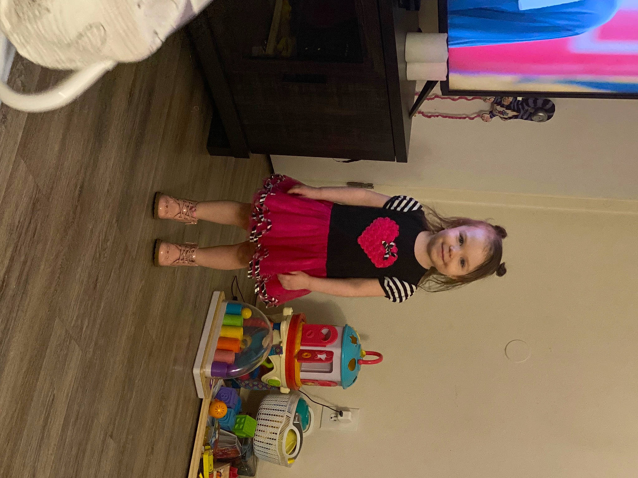 Mia is registered to the contest to win money with this photo: child, flooring, foot, fun, hardwood, human_leg, joy, knee, magenta, person, room, sandal, smile, sneakers, sock, thigh, toddler, varnish, wood, wrist