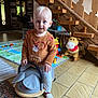 toddler, child, indoor, toy, ride_on_toy, plush_toy, rocking_horse, sweater, floor, carpet, stairs, wood, face, blue_eyes, playroom, window, door, sock, person, furniture