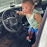 Kairi joined the competition — help win amazing prizes! barefoot, car, child, clothing, curly_hair, dashboard, door, floor_mat, grass, interior, laptop, playful, seat, shorts, smiling, steering_wheel, tank_top, toddler, tree, window