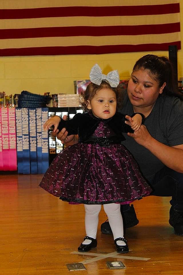 Avianna is registered to the contest to win money with this photo: baby_toddler_clothing, boot, child, entertainment, event, fashion, fashion_accessory, fashion_design, floor, flooring, fun, happy, hardwood, leisure, performing_arts, person, room, sandal, sock, toddler