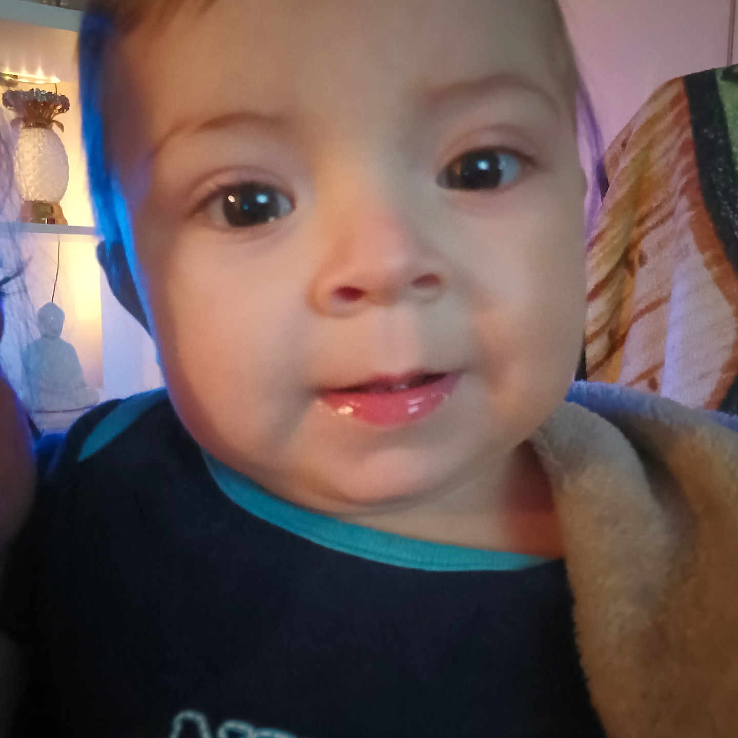 Mason is registered to the contest to win money with this photo: applique, baby, bodypart, clothing, cosmetics, face, finger, hand, happy, head, knitwear, lipstick, mouth, pattern, person, photography, portrait, smile, sweater, t_shirt