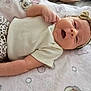 baby, infant, smile, bow, headband, leopard_print, pants, blanket, cartoon, soft_texture, cute, lying_down, happy, child, apparel, skin, face, hand, indoors, comfort