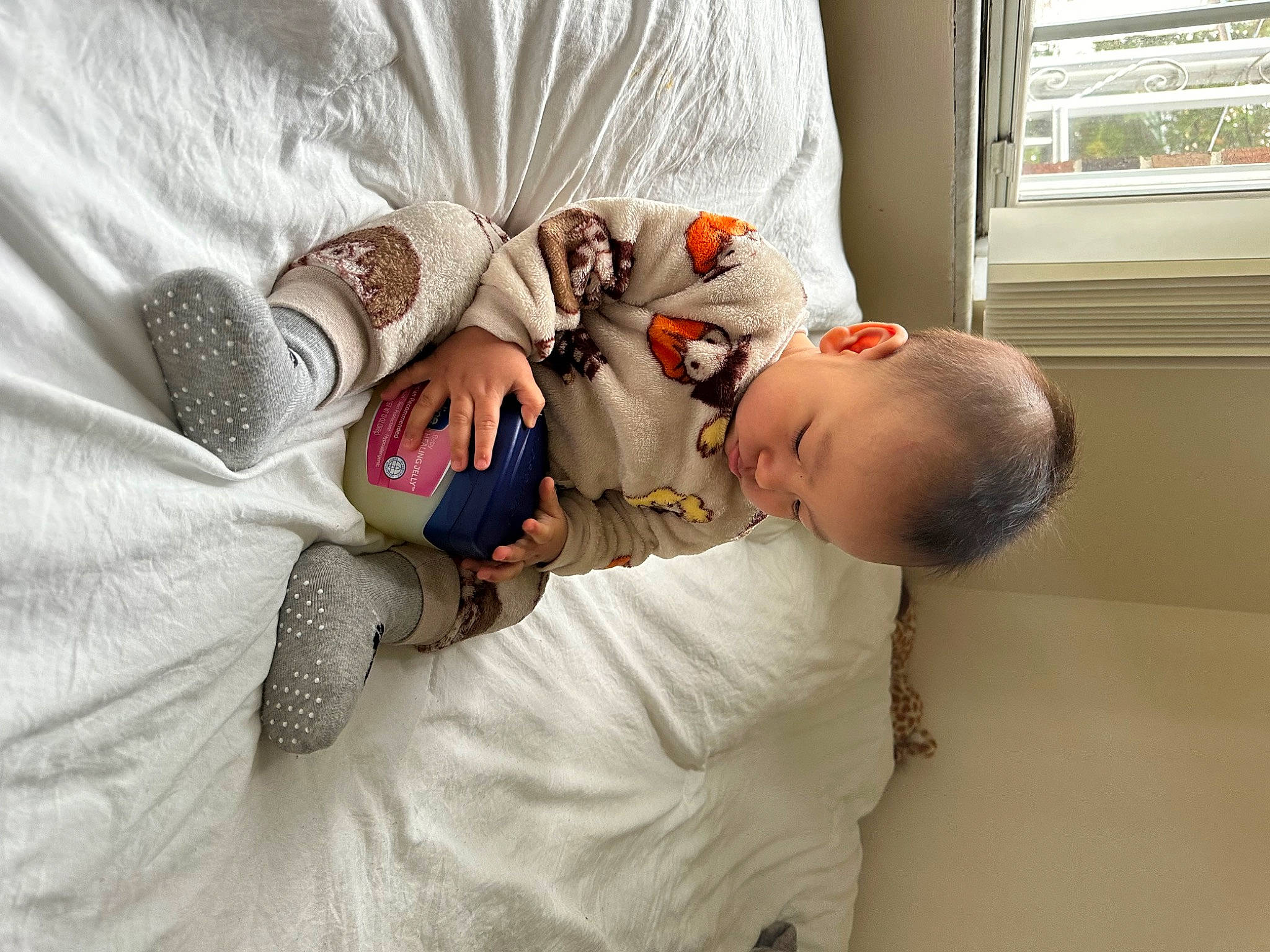 Cyrus is registered to the contest to win money with this photo: baby, baby_products, baby_sleeping, baby_toddler_clothing, bed, bed_sheet, bedding, bedtime, child, comfort, couch, flooring, linens, nap, person, room, sitting, throw_pillow, toddler, window