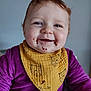 Chloé a rejoint le concours — aidez-le/la à gagner de superbes lots ! baby, child, smiling, face, bib, purple_clothing, yellow_bib, chocolate, messy, happy, indoor, portrait, cute, infant, person, young_child, sitting, closeup, head, eyes