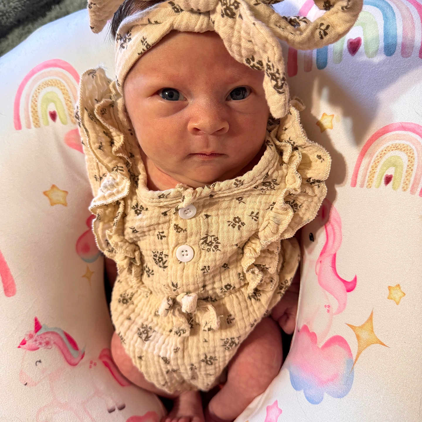 Starlie is registered to the contest to win money with this photo: baby, blanket, blue_eyes, bow, cozy, cute, feet, hands, headband, infant, newborn, onesie, pillow, pink, portrait, rainbow, ruffled_clothing, stars, toes, unicorn