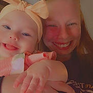 Salem is registered to the contest to win money with this photo: baby, child, toddler, smiling, portrait, selfie, indoor, close_up, faces, two_people, sibling, bow, headband, heart_stickers, holding, hand, casual_clothing, happy, family, warm_lighting